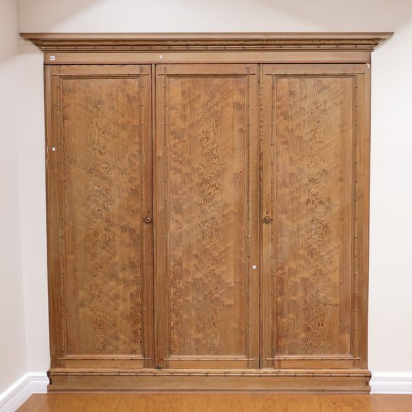 A LATE VICTORIAN PITCH PINE TRIPLE WARDROBE