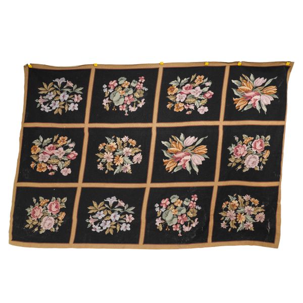 A FRENCH BLACK FLORAL WOVEN WOOL TAPESTRY WALL HANGING OR RUG