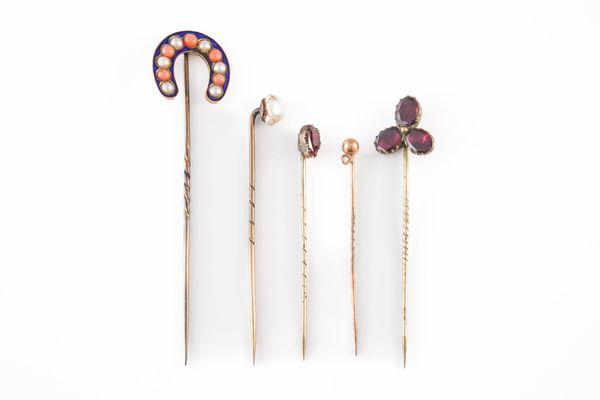 A VICTORIAN CORAL, HALF PEARL AND BLUE ENAMELLED HORSE SHOE STICKPIN AND FOUR FURTHER STICKPINS (5)