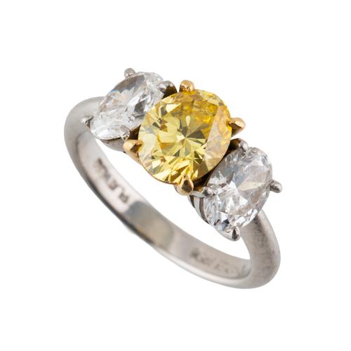 A FANCY YELLOW DIAMOND THREE STONE RING BY CHARLES GREIG