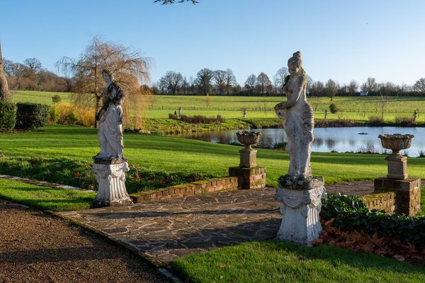 A PAIR OF RECONSTITUTED STONE FIGURES  (2)