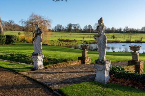 A PAIR OF RECONSTITUTED STONE FIGURES  (2)