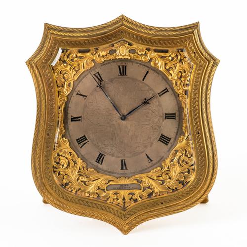 A GOOD VICTORIAN GILT-BRASS AND ENGRAVED SHIELD-SHAPED STRUT TIMEPIECE