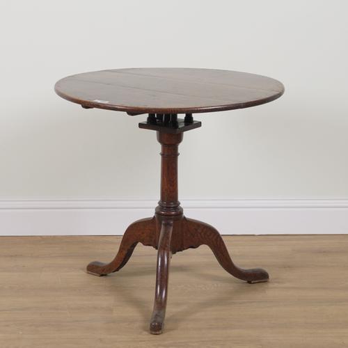 A MID 18TH CENTURY OAK CIRCULAR SNAP-TOP TRIPOD OCCASIONAL TABLE
