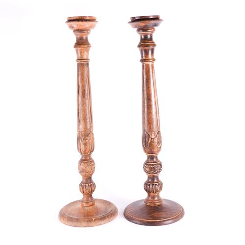 A PAIR OF TURNED AND FLUTED BEECH OVERSIZED CANDLESTICKS (2)