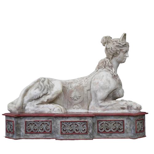 A LARGE PLASTER FIGURE OF A RECUMBENT SPHINX