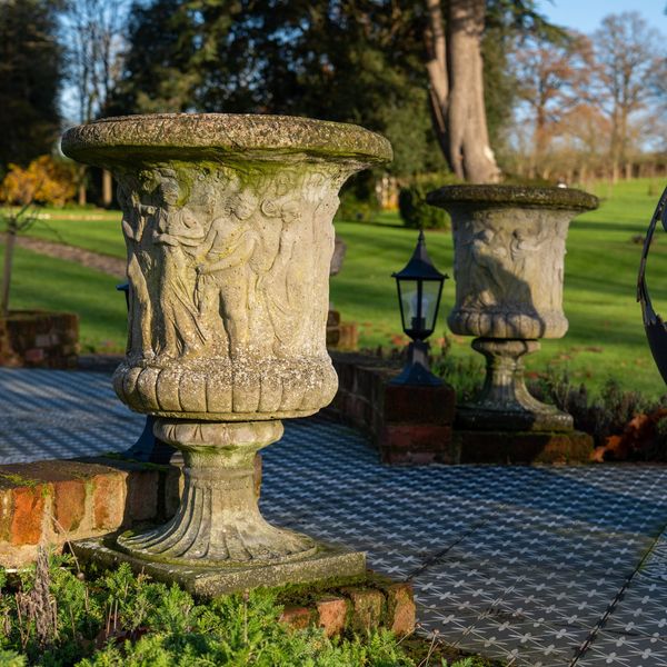 A PAIR OF RECONSTITUTED STONE URNS (2)