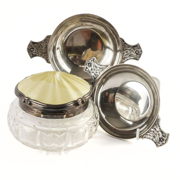 A PAIR OF SILVER TWIN HANDLED QUAICHE AND A LADY'S SILVER AND ENAMEL MOUNTED GLASS DRESSING TABLE JAR (3)