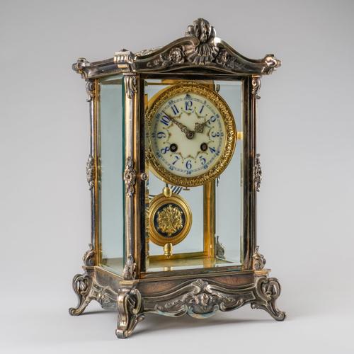 A FRENCH SILVERED FOUR-GLASS MANTEL CLOCK