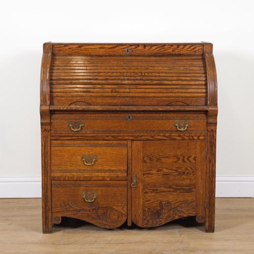 A LATE VICTORIAN OAK ROLL TOP DESK