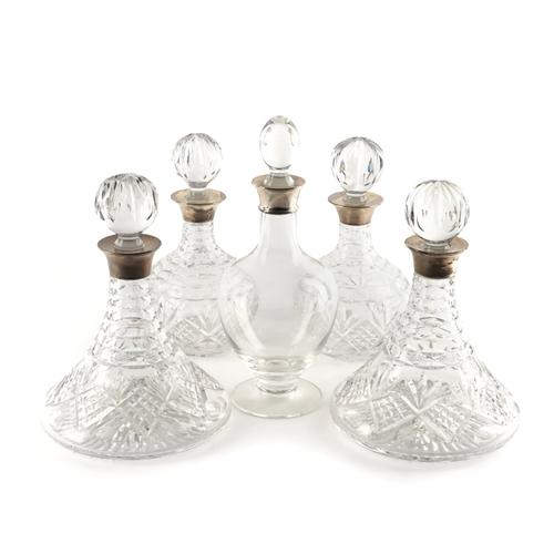 TWO PAIRS OF AND ONE FURTHER SILVER MOUNTED FACETED GLASS DECANTERS
