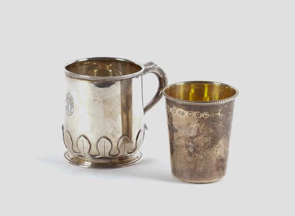 A SILVER MUG AND A SILVER BEAKER (2)