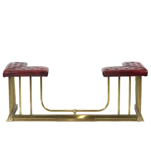 A BRASS AND BUTTON DOWN RED LEATHER CLUB FENDER