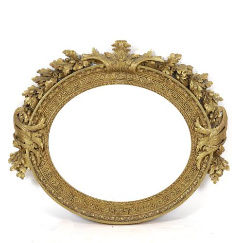 AN EARLY VICTORIAN GILT FRAMED OVAL WALL MIRROR