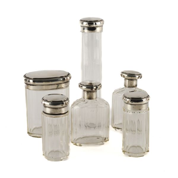 SIX SILVER LIDDED GLASS TOILET BOTTLES AND JARS (6)