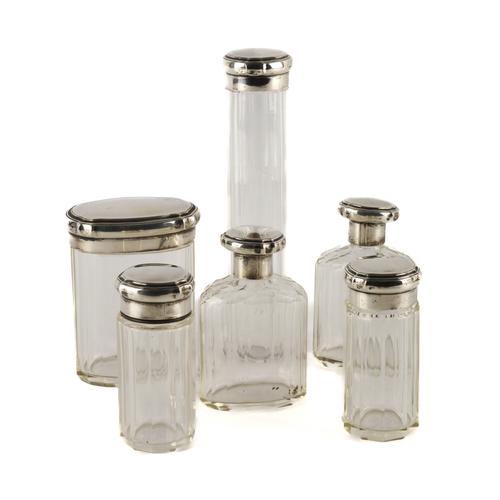 SIX SILVER LIDDED GLASS TOILET BOTTLES AND JARS (6)