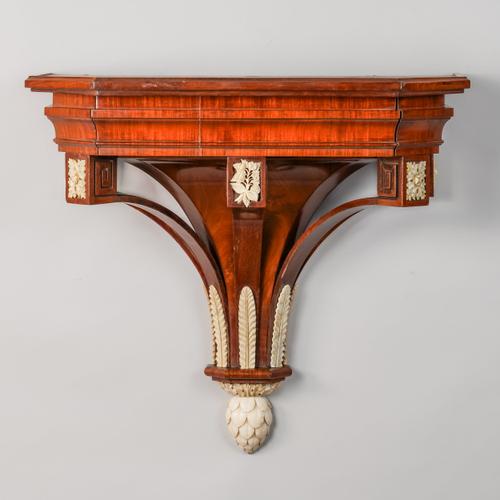 A CARVED-IVORY-MOUNTED MAHOGANY LARGE WALL BRACKET