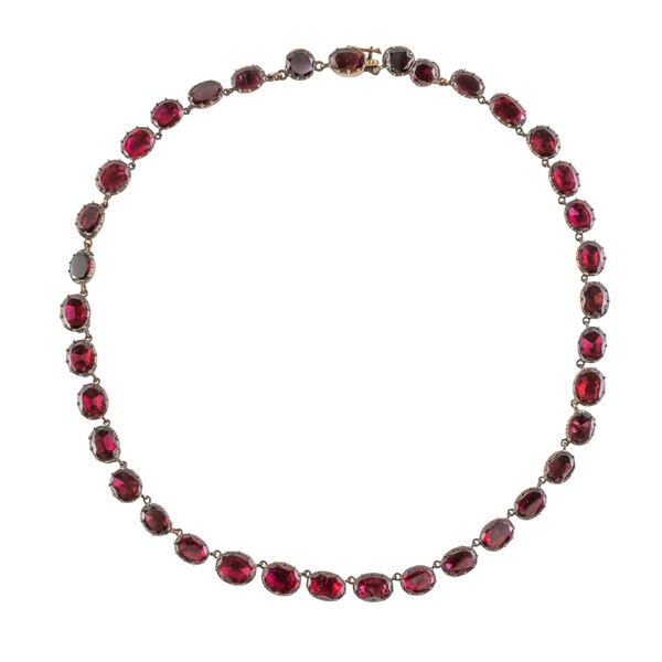 A FOIL BACKED FLAT CUT GARNET NECKLACE (2)