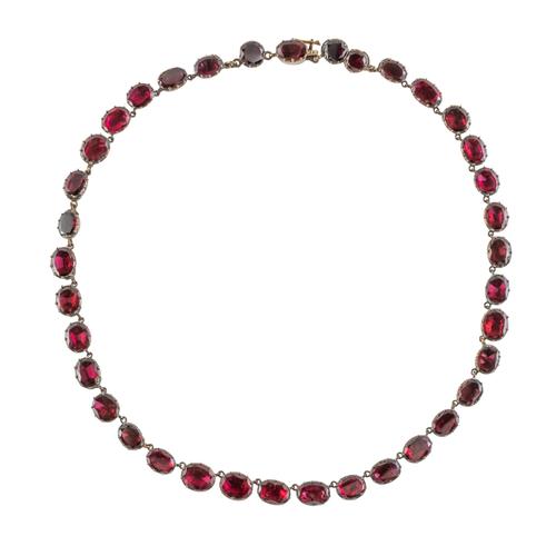 A FOIL BACKED FLAT CUT GARNET NECKLACE (2)