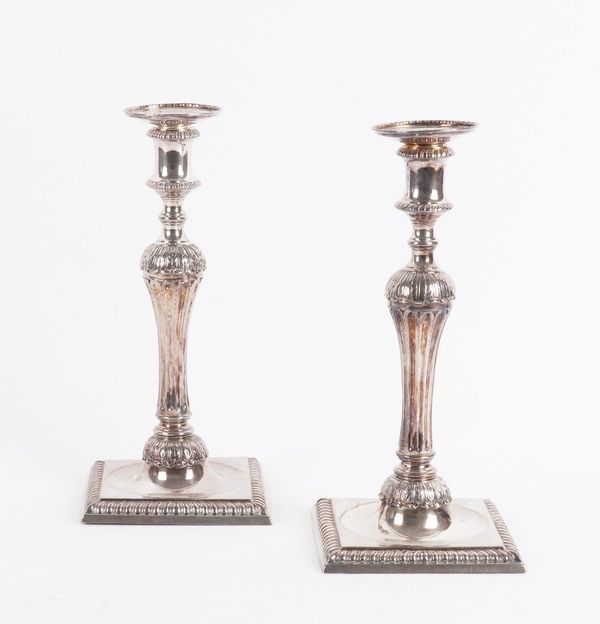 A PAIR OF GEORGE III CAST SILVER CANDLESTICKS