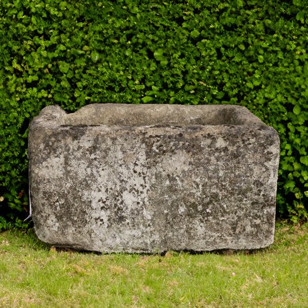 A RECTANGULAR CARVED COTSWOLD STONE TROUGH