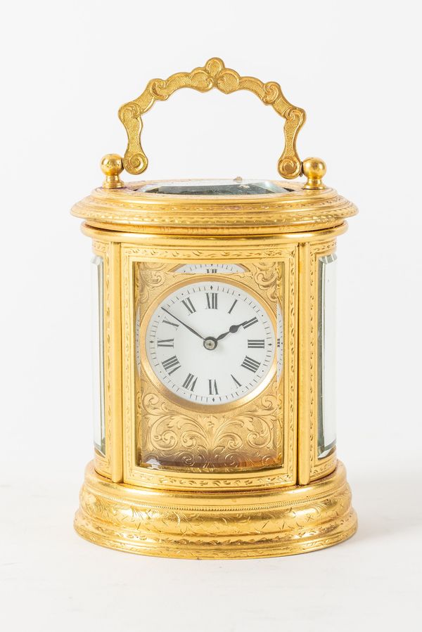 A FRENCH ENGRAVED GILT BRASS OVAL MINIATURE CARRIAGE CLOCK