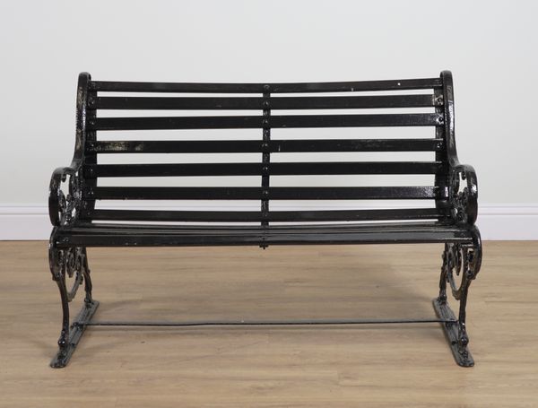 A 19TH CENTURY BLACK PAINTED GARDEN BENCH ON FOLIATE CAST METAL ENDS