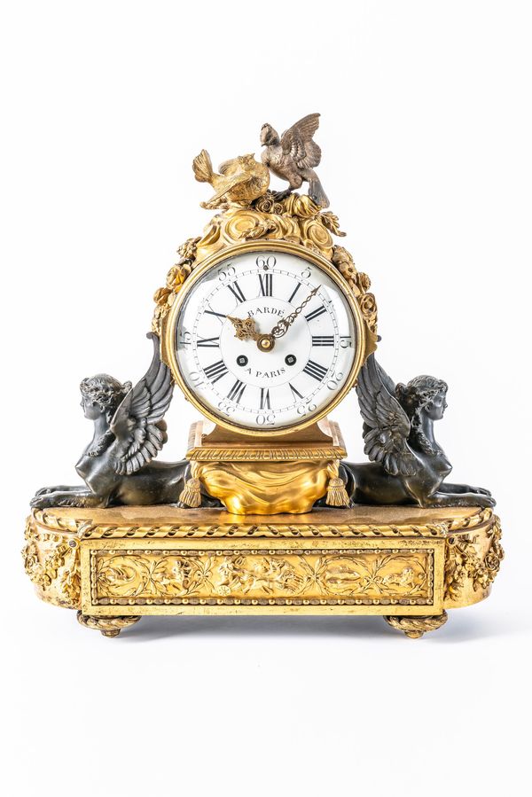 A FRENCH ORMOLU AND BRONZE MANTEL CLOCK