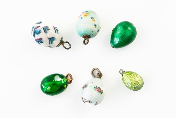 A GROUP OF SIX EGG CHARMS (6)