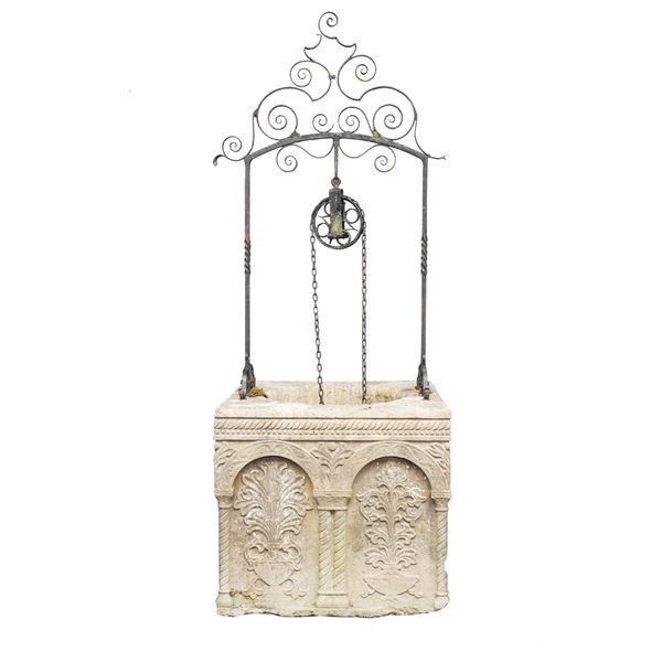 A 19TH CENTURY ISTRIAN CARVED STONE WELL HEAD WITH WROUGHT IRON OVERTHROW