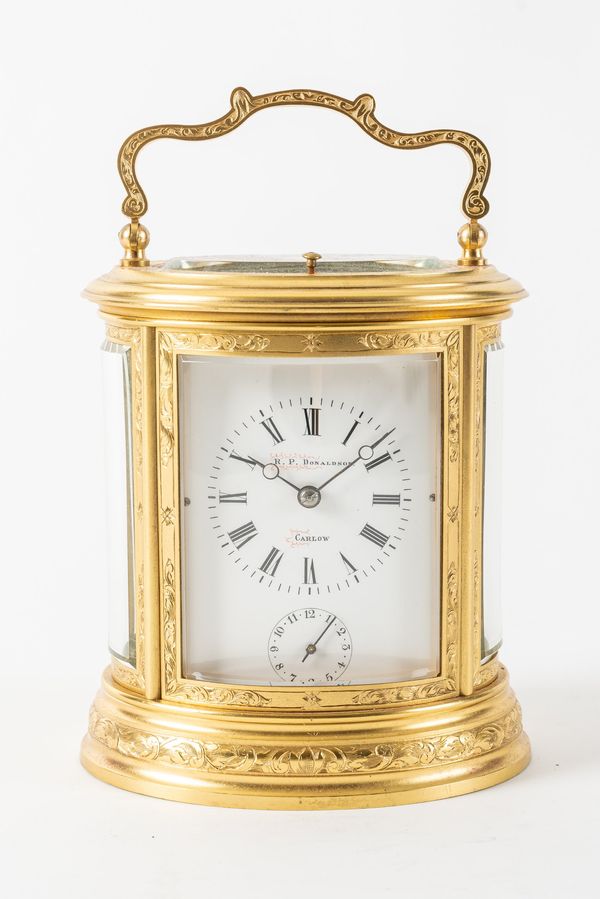 A  FRENCH ENGRAVED GILT BRASS STRIKING AND REPEATING OVAL CARRIAGE CLOCK