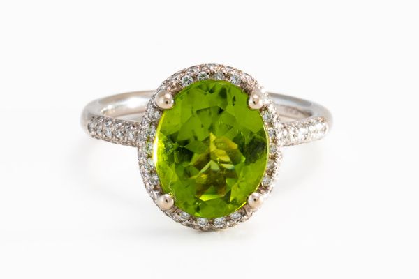 A PERIDOT AND DIAMOND RING