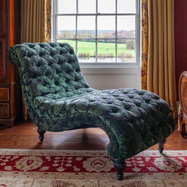 AN OVERSIZED PATTERNED GREEN FLORAL UPHOLSTERED SCROLL SHAPED CHAISE LONGUE