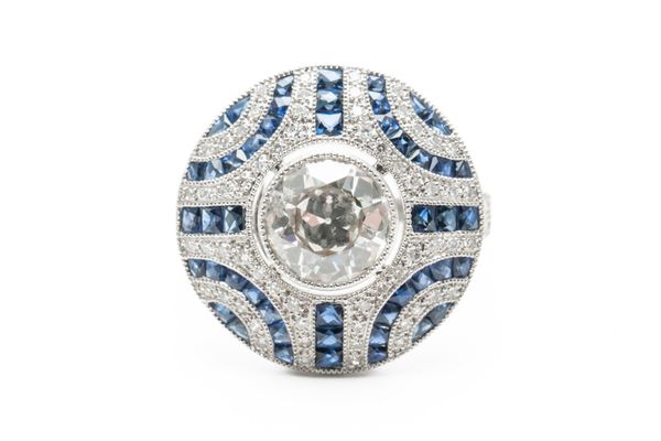 A SAPPHIRE AND DIAMOND TARGET STYLE RING