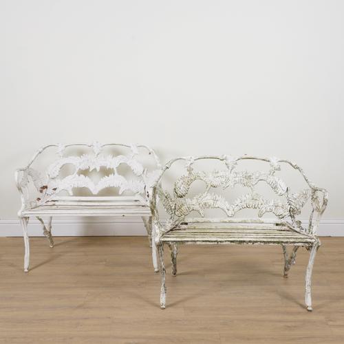 AFTER COALBROOKDALE; A PAIR OF FERN AND BERRY PATTERN WHITE PAINTED ALUMINIUM GARDEN BENCHES (2)