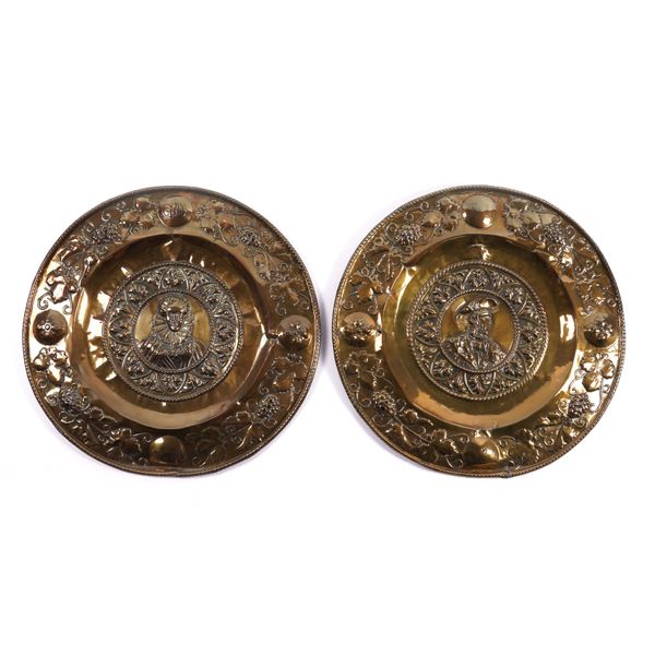 A PAIR OF 19TH CENTURY EMBOSSED BRASS CHARGERS (2)