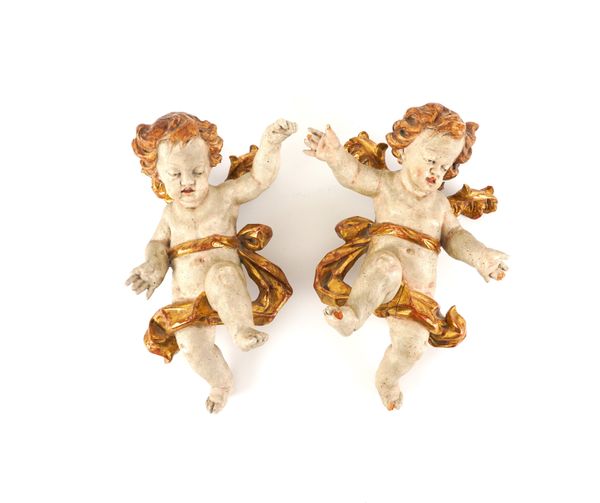 AN OPPOSING PAIR OF  SOUTH GERMAN / AUSTRIAN BAROQUE PARCEL-GILT POLYCHROME WINGED PUTTI (2)