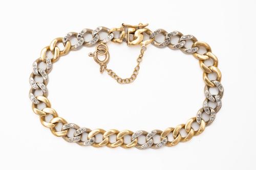 A BICOLOUR DIAMOND SET CURB BRACELET