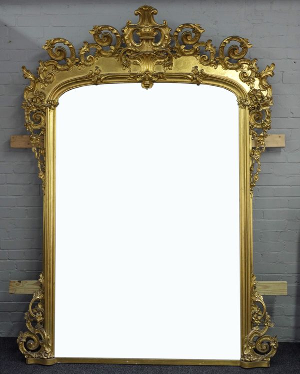 A LARGE VICTORIAN GILT FRAMED ARCH TOP OVERMANTEL MIRROR