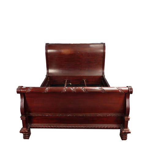 A 20TH CENTURY HARDWOOD SLEIGH BED