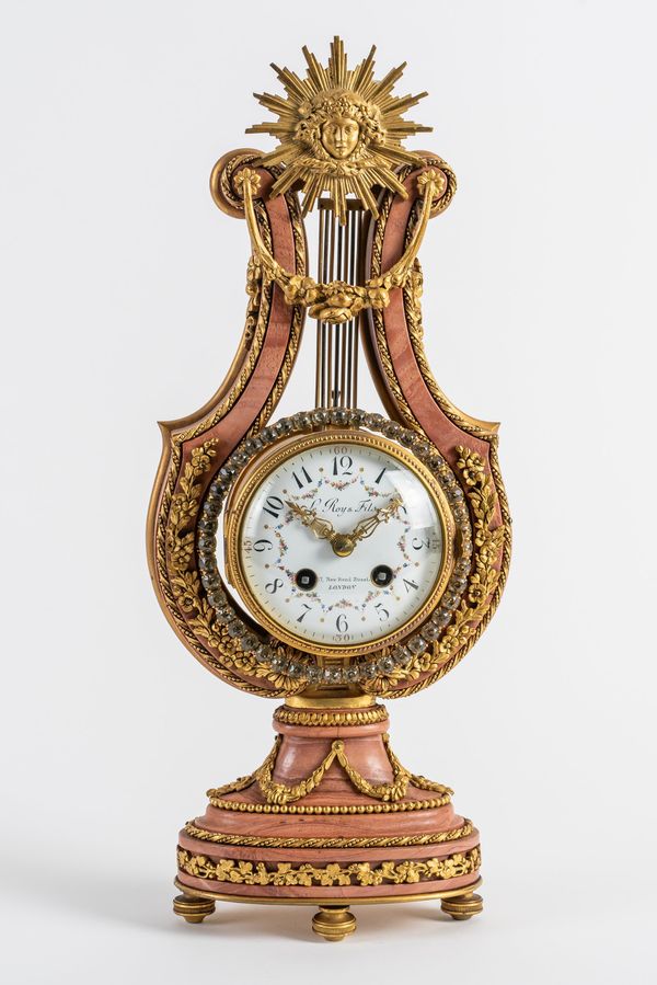 A FRENCH ORMOLU AND PINK MARBLE LYRE CLOCK