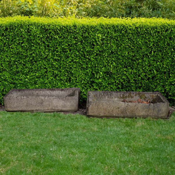 A ROUGHLY HEWN RECTANGULAR STONE TROUGH (2)