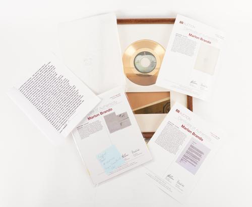 FILM & POP MEMORABILIA: A FRAMED GOLD DISC FOR ‘HEY JUDE’, A QUANTITY OF MARLON BRANDO MEMORABILIA AND A FILM POSTER (QTY)