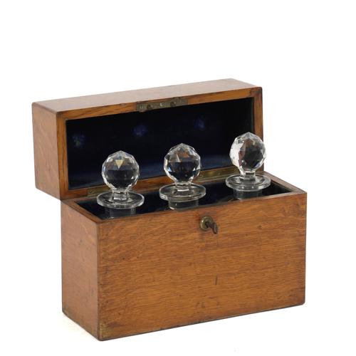 A VICTORIAN OAK TRIPLE DECANTER BOX