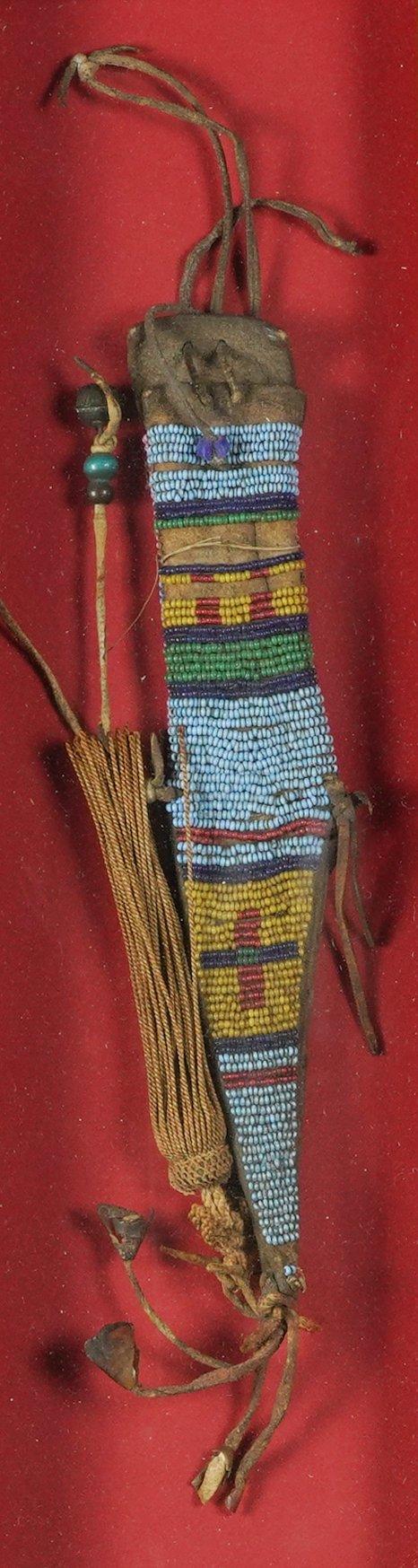 A NATIVE AMERICAN PLAINS INDIANS GLASS SEED BEAD AND LEATHER KNIFE SHEATH
