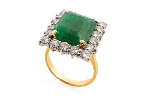 AN EMERALD AND DIAMOND CLUSTER RING