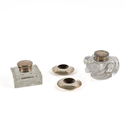 TWO SILVER MOUNTED GLASS INKSTANDS AND A PAIR OF SILVER TEA LIGHT HOLDERS (4)
