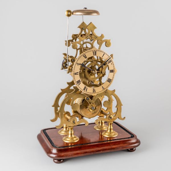 A VICTORIAN BRASS SKELETON TIMEPIECE WITH ONE-IN-PASSING STRIKE