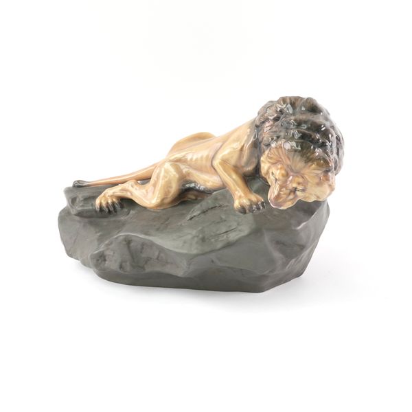 A LARGE ROYAL DOULTON MODEL, LION ON ROCK, HN 2641