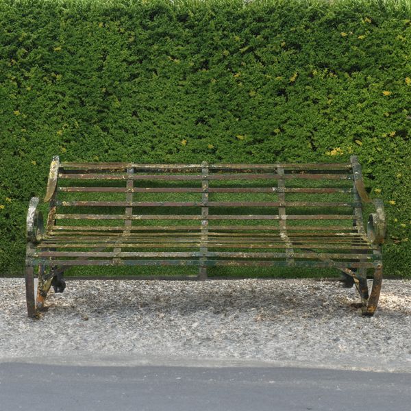 A 19TH CENTURY GREEN PAINTED STRAP IRON GARDEN BENCH